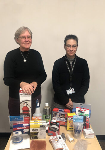 Pat and Diana pose in front of giveaway items at the Tompkins County Health Department